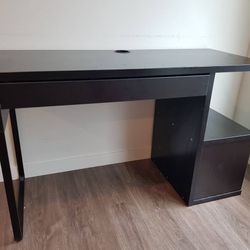 Brown black IKEA MICKE desk with compartment cubbies