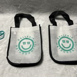 2 small while grocery shopping reusable tote bags 2 rubber bracelets