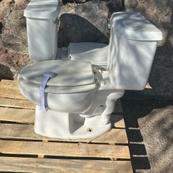 Two 6 month old toilets…. Complete with  tank accessories
