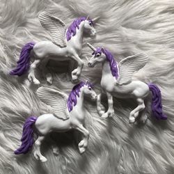 3 white/purple toy unicorn horses with wings
