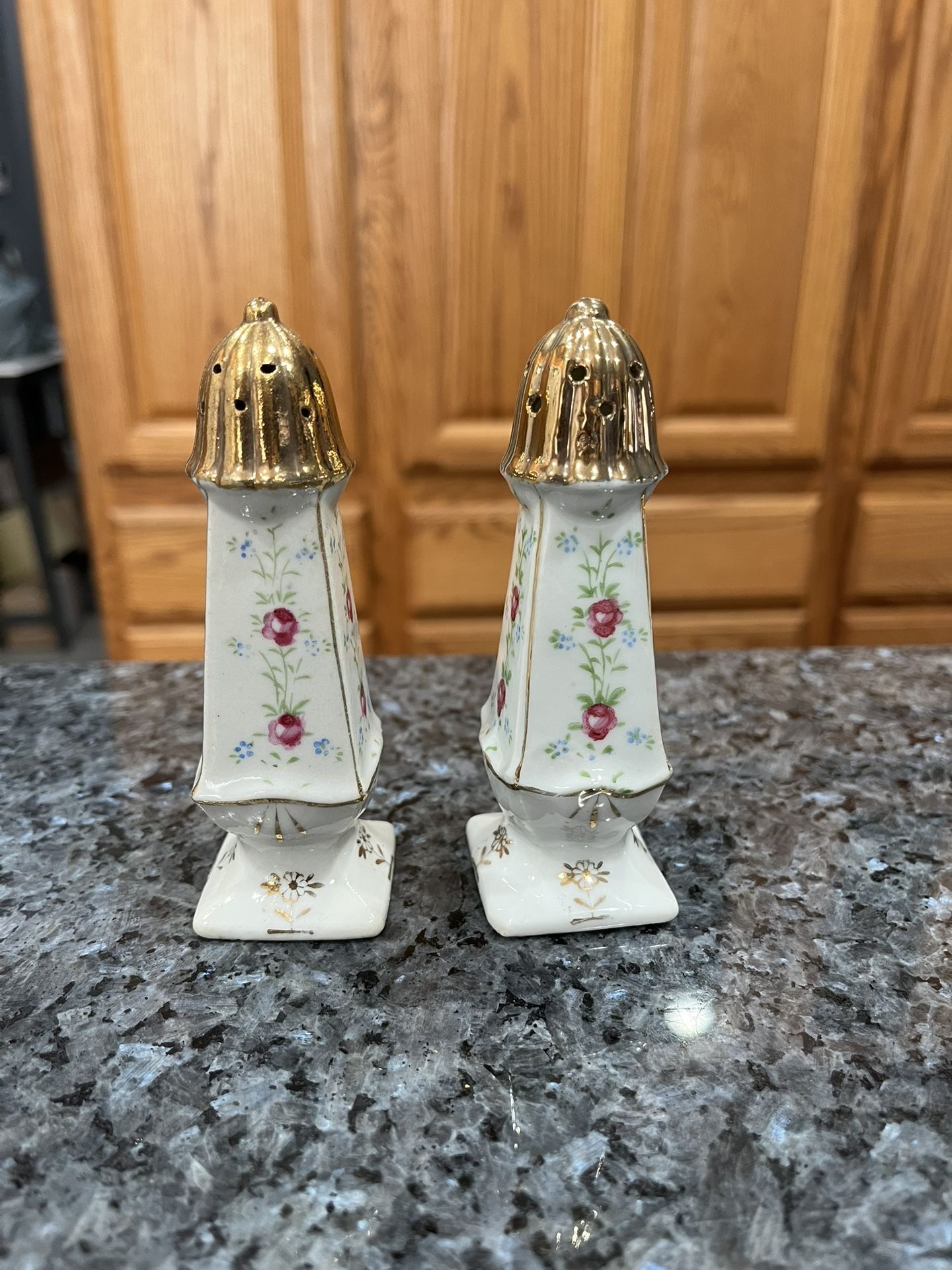 Vintage Hand Painted Porcelain White Floral with gold trim pair of salt and pepper shakers. Size approximately 4 1/4 inches tall. Preowned