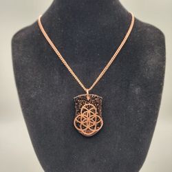 Shungite & Quartz Orgonite Shield Necklace – Copper Flower of Life, 20″ Chain

This orgonite shield necklace combines sacred geometry, natural crystal