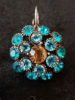 $10. Starburst circular earrings. Bronze back. Brown, teal and ocean blue glass stones lever back. 1 1/8 inch long. 7/8-in diameter.