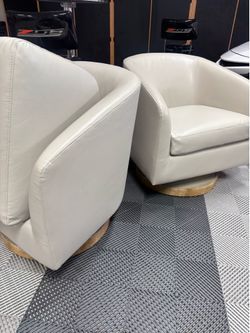 Two swivel leather chairs
