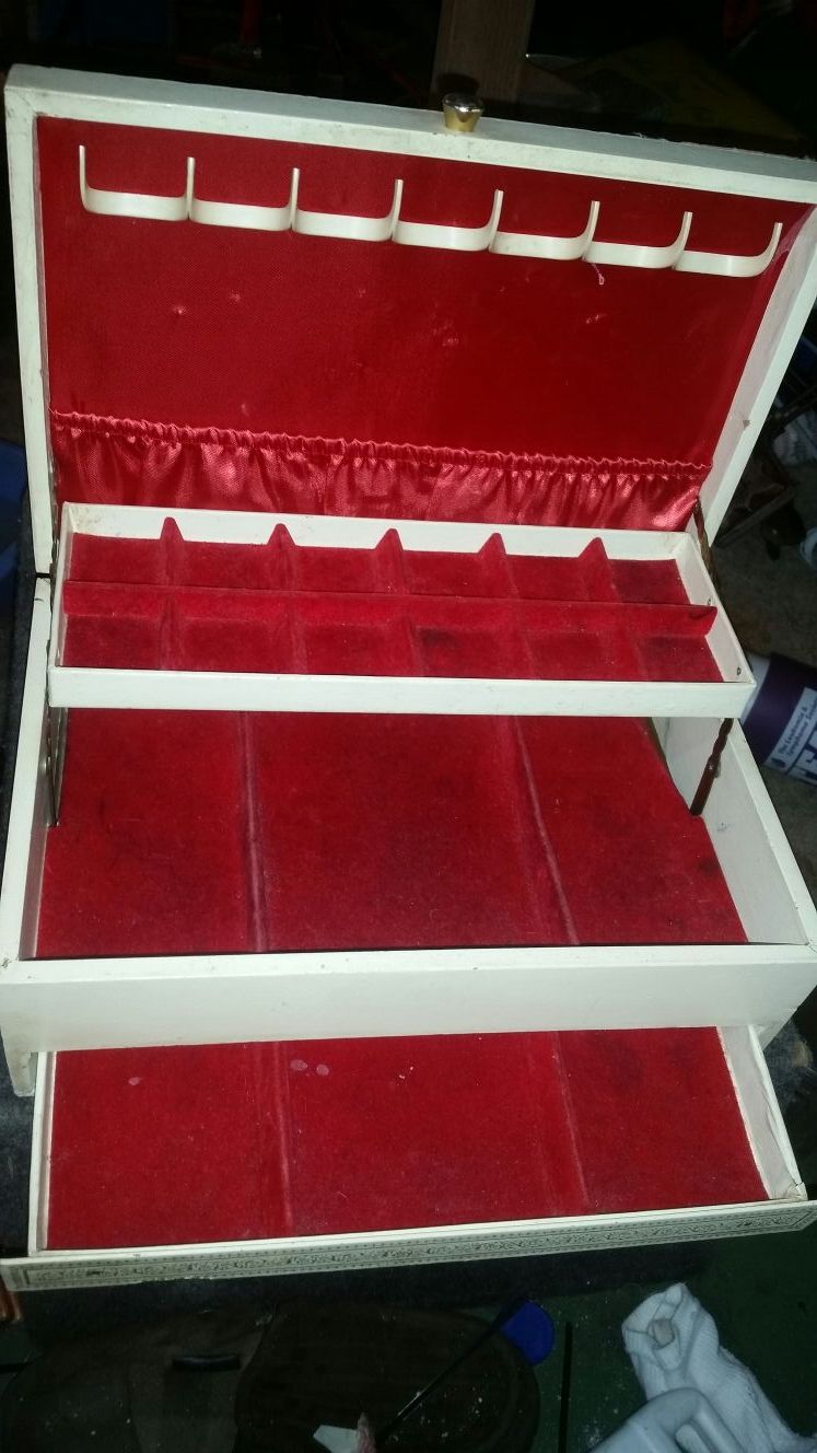 Vintage jewelry box with red velvet drawers