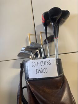 Vintage golf clubs and leather bag