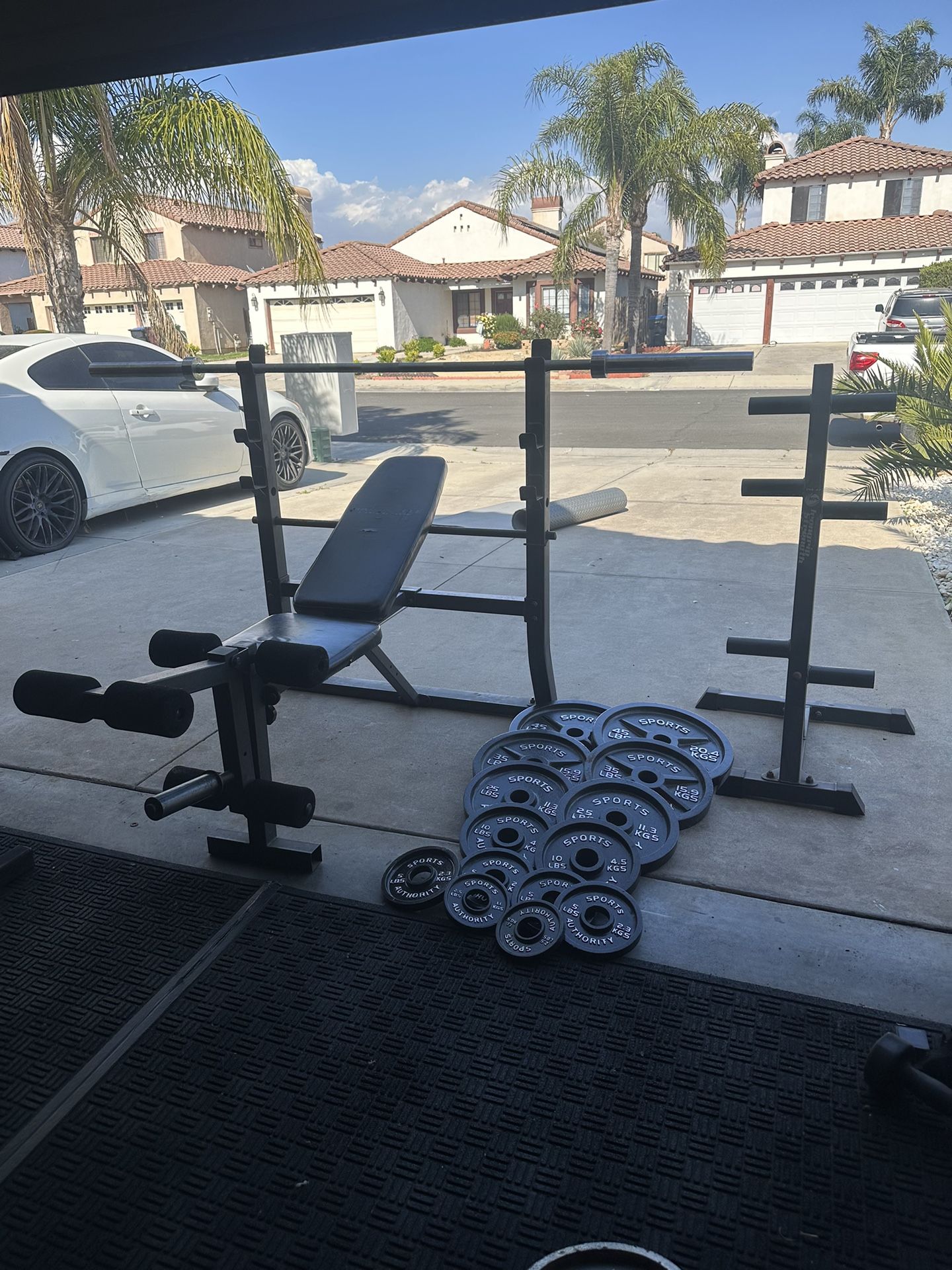 Bench press with 255lbs of Olympic weights plus 7ft bar with weights tree