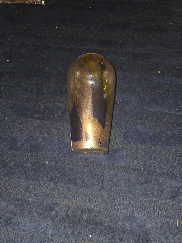 This one0 inch tall iridescent glass art vase .