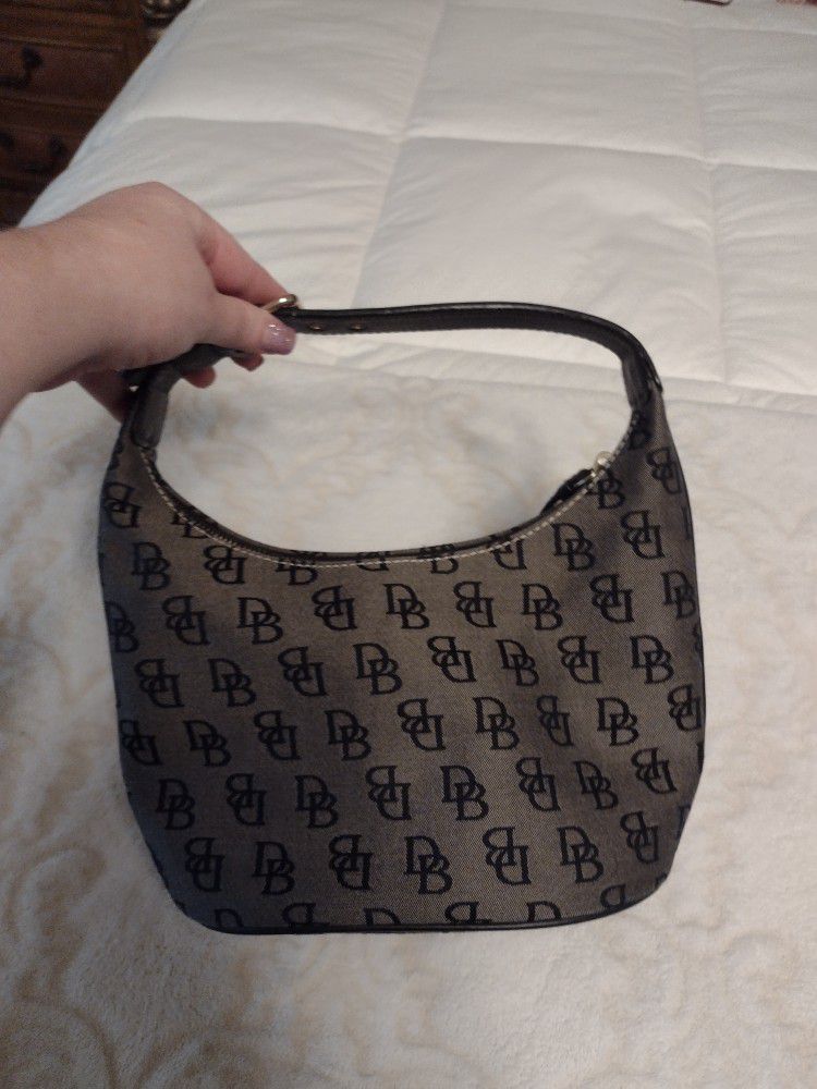 Dooney and Bourke Zip Black Logo Canvas Small Bucket Hobo Handbag . Black and gray in color, in great condition. Measures 10 inches long, 5 inches wid