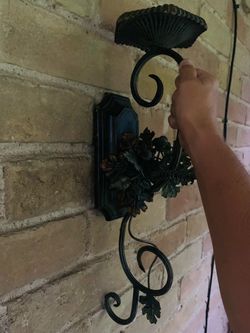 Vintage rustic-style wrought iron metal wall candle sconce featuring scrollwork and decorative acorn and leaf accents