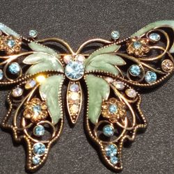 A beautiful vintage Avon enameled butterfly brooch with rhinestones.