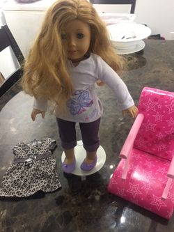 American girl doll with outfits and chair