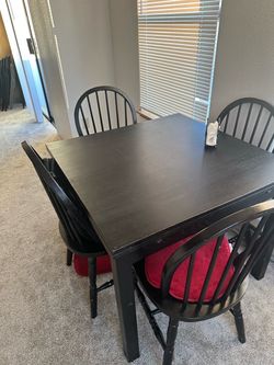 Black extendable table with 4 chairs