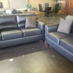 Dark brown faux leather sofa and loveseat