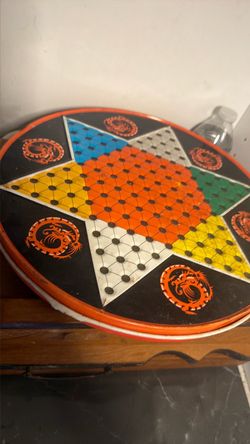 Chinese checkers and flip side has chess board or checkers comes with some marbles for about four players
