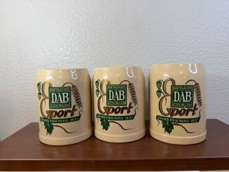 This product is a set of 3 McCoy stoneware DAB beer stein mugs