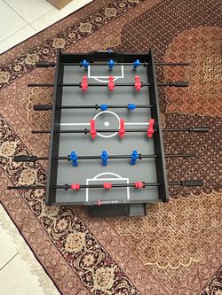Foosball Table with Red and Blue Players