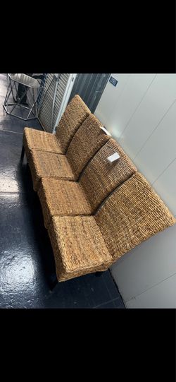 Woven  natural-fiber dining armchairs with a tropical/boho