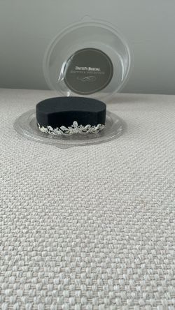 A semi-circular, jeweled headpiece