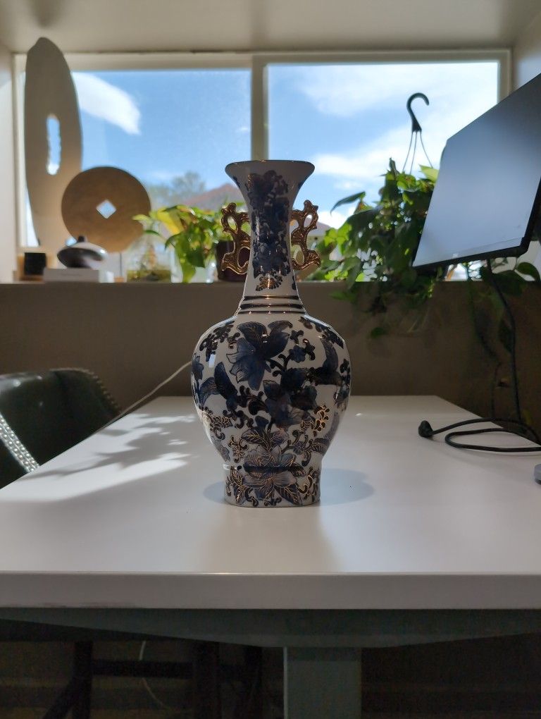 Chinese gilt blue, gold and white porcelain vase with floral pattern.