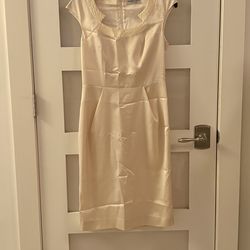 Cream-colored cocktail dress with a detailed collar from the Maria Coca brand, suitable for formal events or civil weddings.