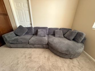 Couch 4-piece modular jumbo corduroy sectional with a curved chaise/end module.