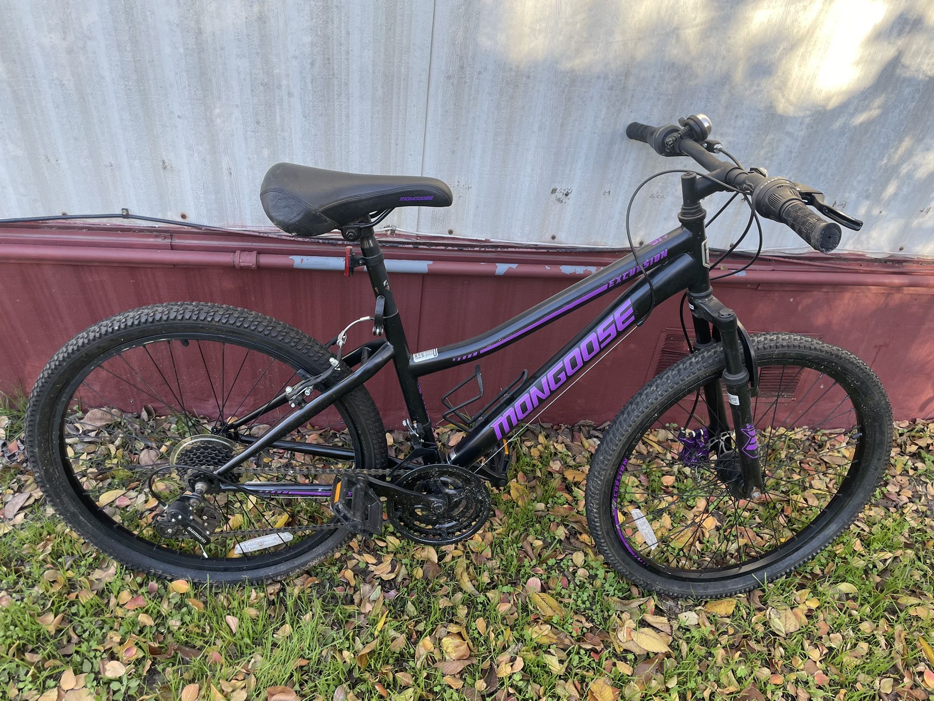 Mongoose Excursion mountain bike, 24-inch wheel, 21 speeds, girls frame, black / purple