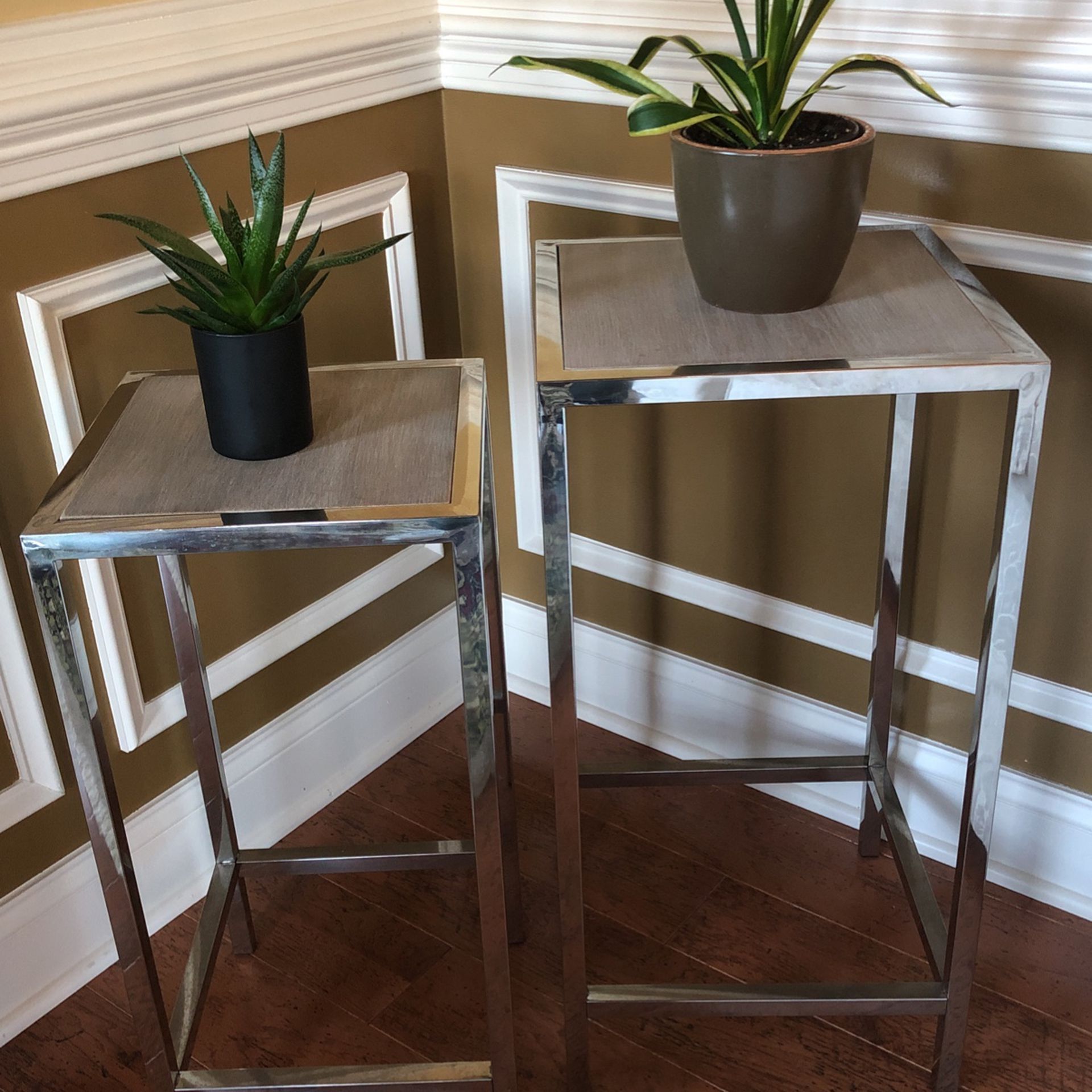 2 tables with chrome legs and grayish wood tops