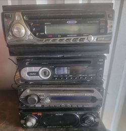 4 Vintage car radios include wiring harnesses and removable faceplates