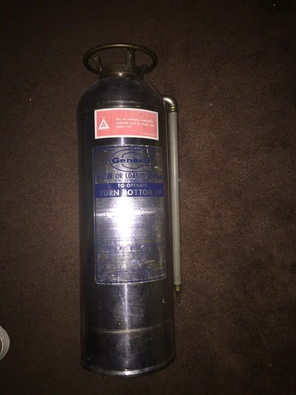 Nice old general stainless fire extinguisher . Slit cut in lid for use as a change bank. Nice decor piece