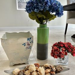 Artificial flowers with a beautiful vase and decorative items.