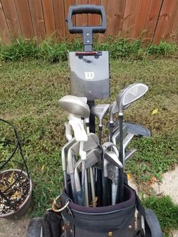 Golf bag full of golf clubs and other golf stuff