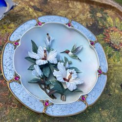 This is a decorative collector's plate titled "Rose-Colored Dawn" by artist Lena Liu.