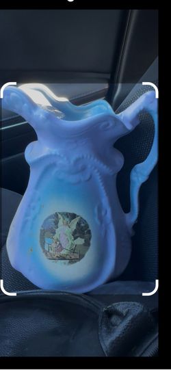 This vintage light blue glassware piece Fenton Blue Satin Glass "Water Lily" pitcher.