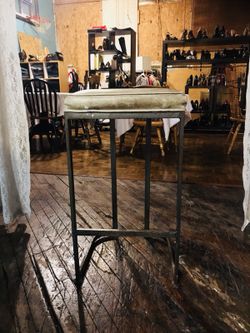 brown metal framed tan padded chair