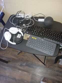 Alexa, headphones, logic key boards, iPhone, android charger and folding table