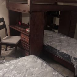 Bunkbeds with built-in desk, drawers, and rollout bottom bed