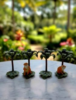 4 Petites Choses Monkey and Palm Tree Candlestick set, a notable example of 20th-century Hollywood Regency or Palm Beach Regency style.