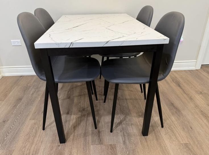 MOVING SALE. Dining table with 4 grey chairs. Less than 3 months old. Very good condition.