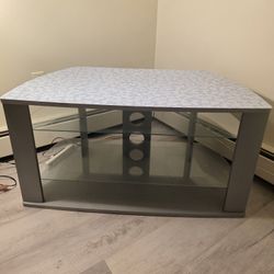 Light blue TV stand with glass shelves