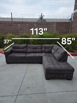 Up for sale is a super comfortable, plush dark gray/charcoal L-shaped sectional sofa. It features stylish tufted detailing, contrast stitching, and de