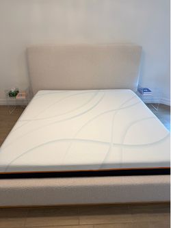 King size beige upholstered bed with Tempur-Pedic LuxeAdapt Firm 13” mattress.