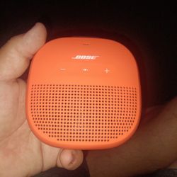 Orange Hand Held Bose Speaker