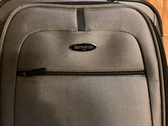 Samsonite Carry On Luggage.( Grey) Dimensions are: 14”W —9”D — 22”H