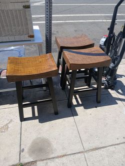 bar stools feature a saddle-style seat $45 each