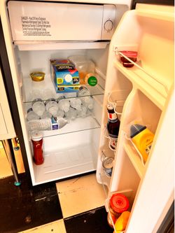 Black mini fridge with little freezer