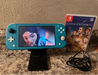 NINTENDO SWITCH LIGHT WITH A GAME AND USB  CHARGER CORD AND HOLDER INCLUDED / WORKING GREAT