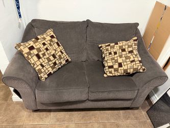Brown couch with additional pillows