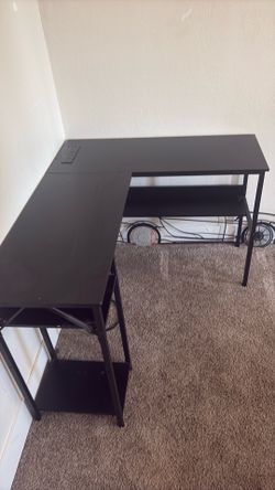 Black desk with power strip