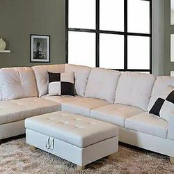 New white leather sectional and ottoman